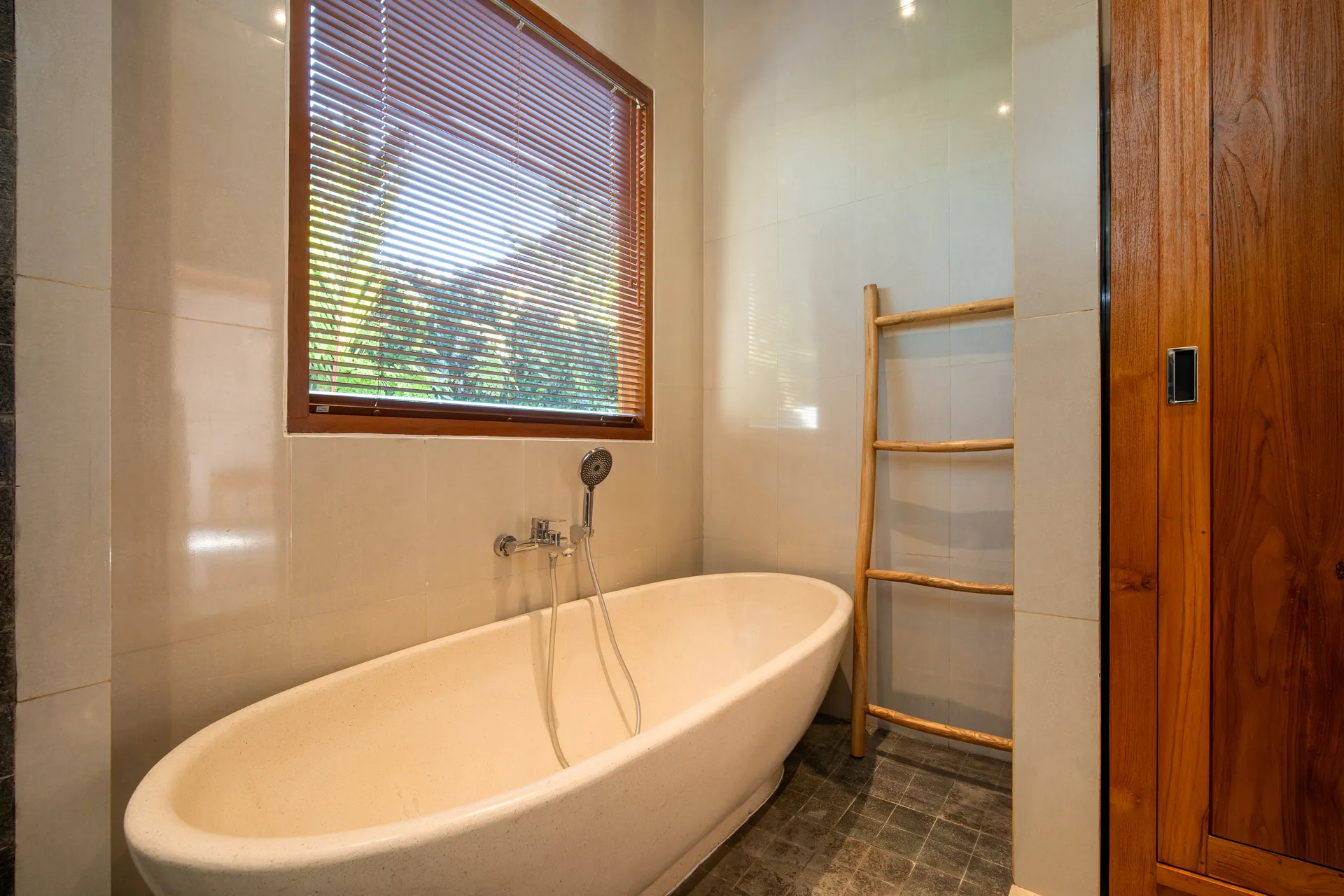 Freestanding bathtub next to window