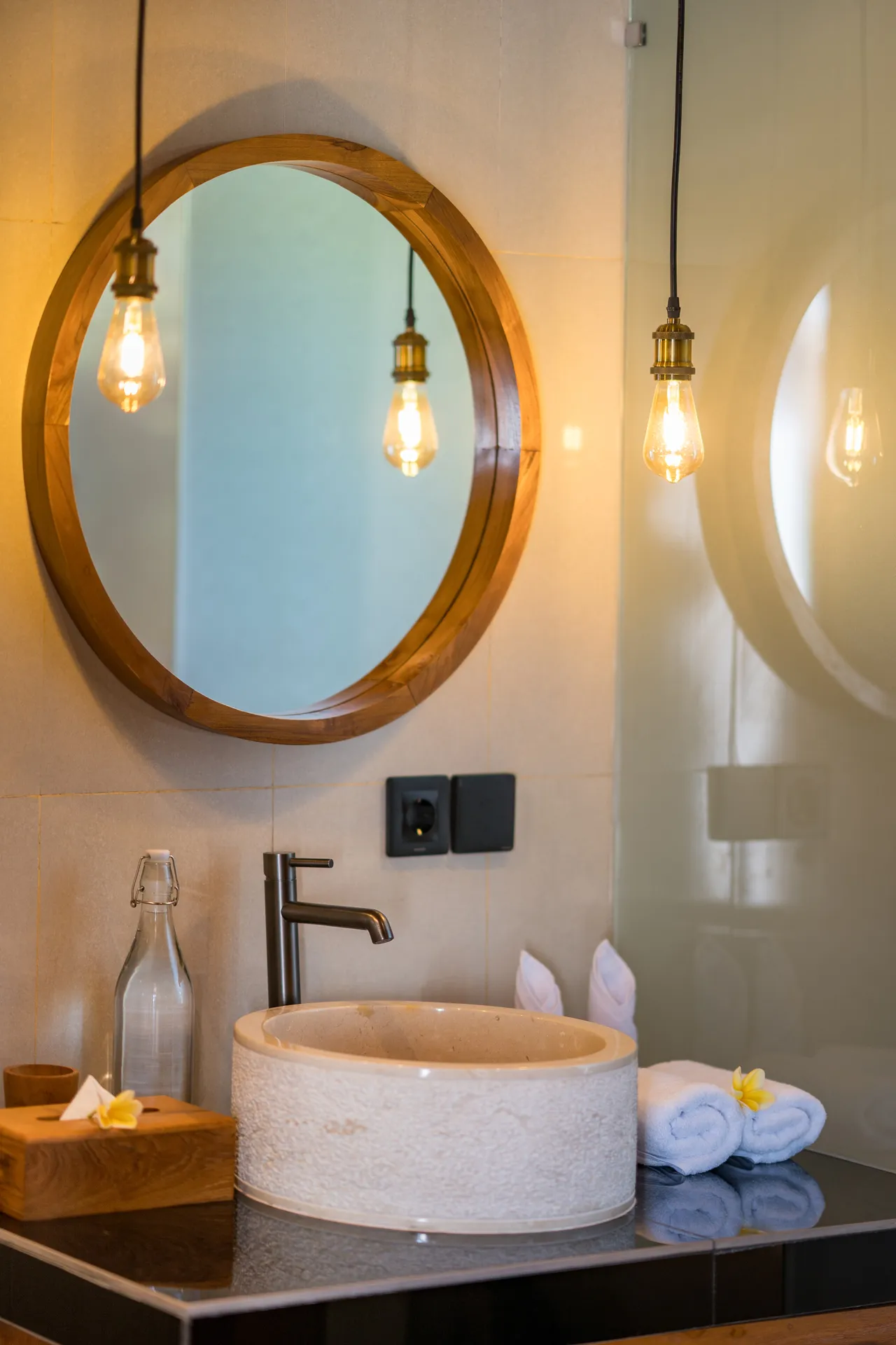 Bathroom sink and hanging light bulbs